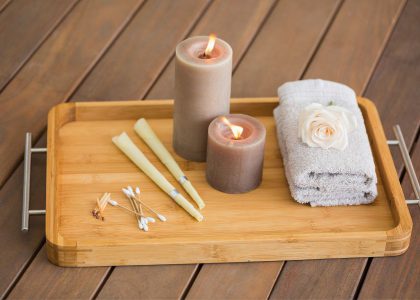 candles in a tray with cotton buds, matches and a towel